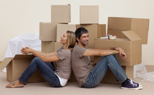 Movers carrying furniture through a property during relocation