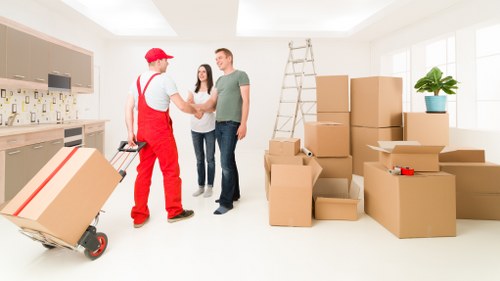 Local moving team handling boxes and furniture in West Hampstead