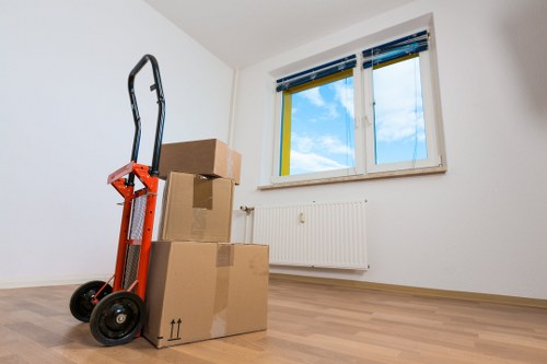 Trained movers handling boxes and furniture carefully in a West Hampstead removal